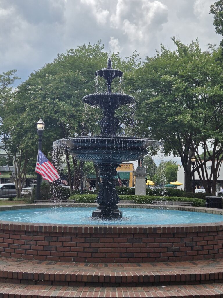 Marietta GA town square fountain with American flags and trees